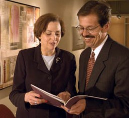 business woman and man looking at a document