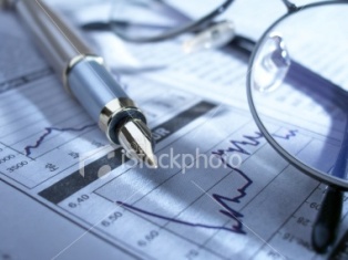 image of stock market chart with pen and magnifying glass