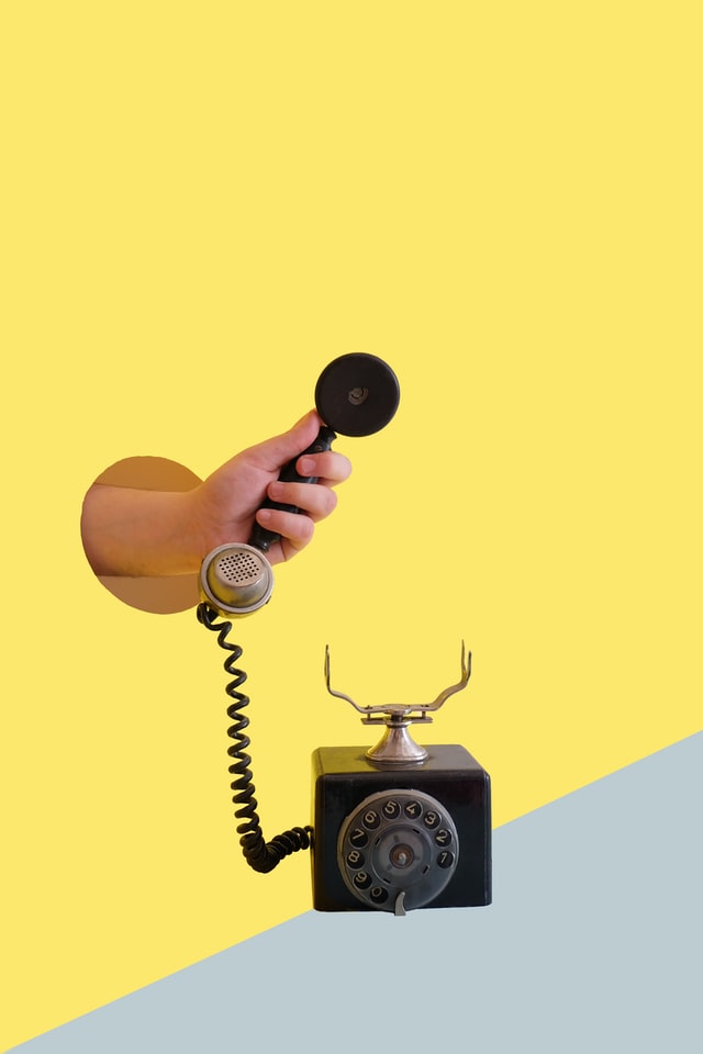 Picture of hand holding a vintage telephone