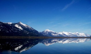 mountains and sky reflected in lake