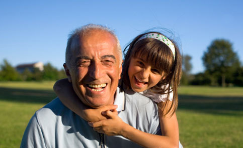 smiling grandfather and granddaughter