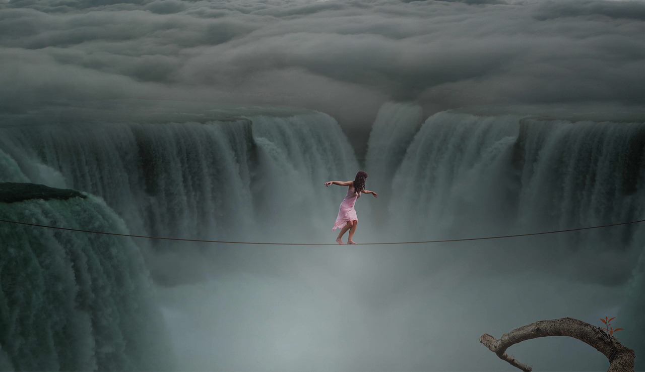 A woman walks on a tightrope across Niagra Falls