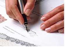  woman signing a stock certificate