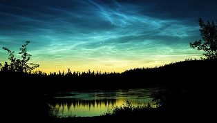 Yukon River at night with noctilucent clouds