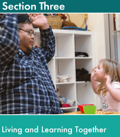 An ECE educator and child play in a centre with their hands in the air