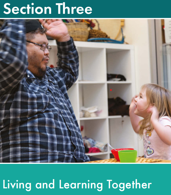An ECE educator and child play in a centre with their hands in the air